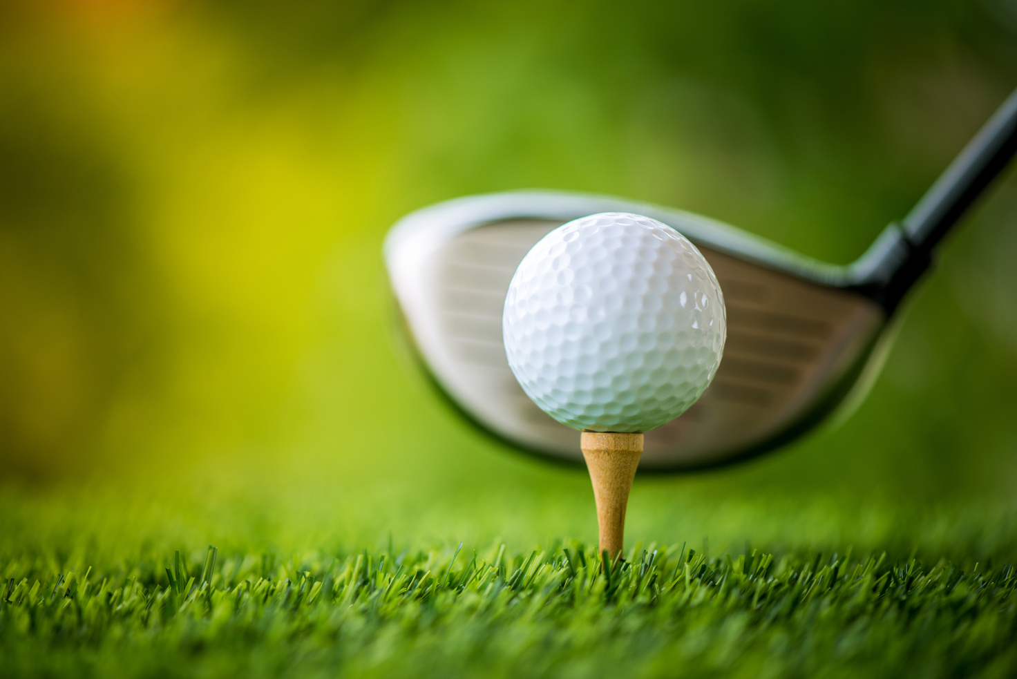 teeing off with golf club and golf ball